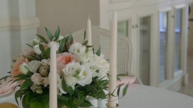 Decorating a Festive table. Wedding Table Decoration with Bouquets of Natural Fresh Flowers for a Family Feast