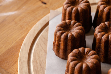 French dessert Canele on .marble background. Homemade bakery concept.