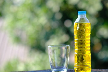 bottle and glass of water on table