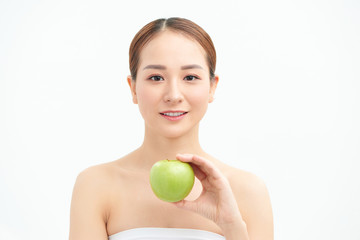 Smiling pretty model holding apple while posing on white background