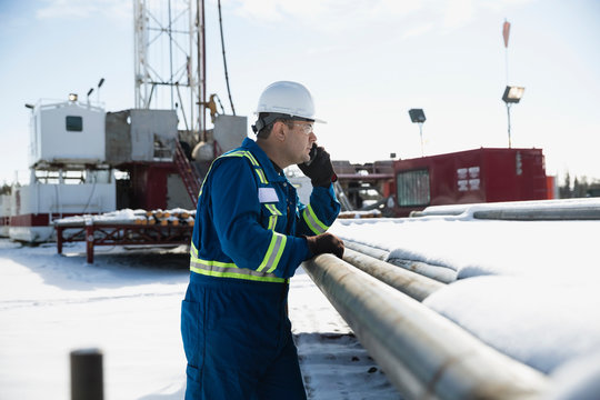 Male Worker Talking Cell Phone Snowy Gas Plant