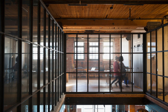 Women Walking Along Elevated Walkway Industrial Office