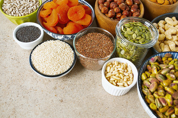 fresh nuts and dried fruis on granite surface