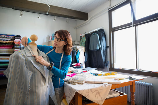 Dressmaker Measuring Suit On Dressmakers Model