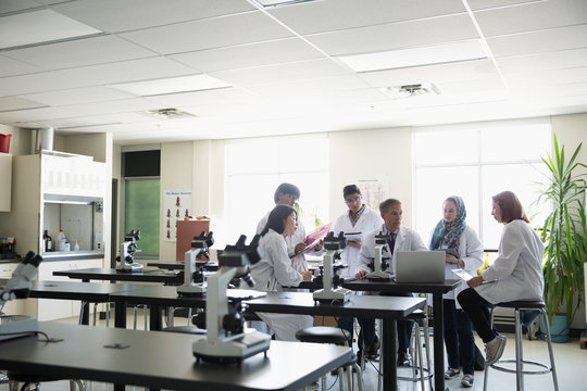 Professor and college students in science laboratory