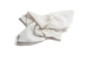 Used and crumpled wet paper towel on a white background. Moisturizing square disposable napkin. Hygiene of the human body.