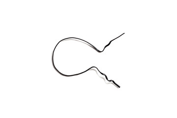 Black used piece of wire for pulling electric cables and other things on a white background isolate. Black plastic coated wire tie. Cable flexible tie tools for packing. Top view.