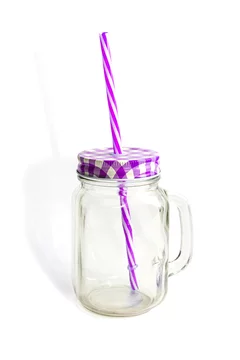Violet glass cup with lid and straw on a white background isolated. Mason  jar with handle and screwed down cap. Empty mug no spill. Stock Photo