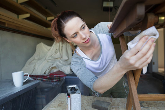 Woman Staining Wood Furniture Home Improvement Project