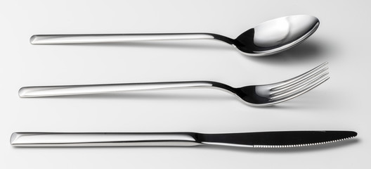 Spoon, fork and knife on a white background