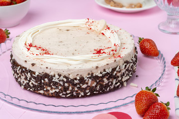 Chocolate cake with whipped cream icing on plate