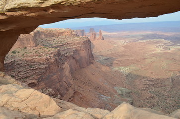 Summer in Utah: In Island in the Sky District of Canyonlands National Park Looking Through Mesa Arch at Buck Canyon, the White Rim, Monster Tower, Washer Woman Arch, Airport Tower and La Sal Mountains
