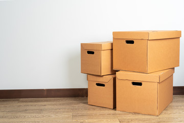 Group of brown carton boxes on wooden floor