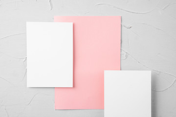 Three pieces of blank paper on grey background, top view, copy space