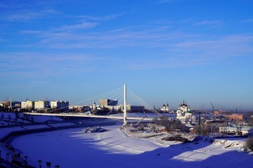 Panoramic view on bridge over icy river in winter sunny day