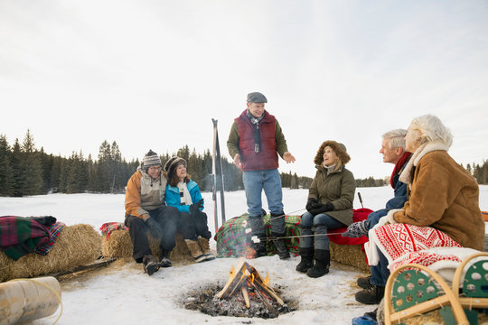 Group of friends enjoying winter bonfire