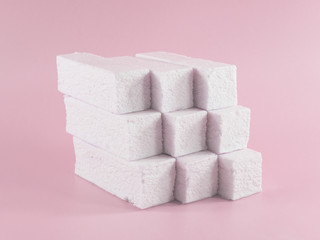 Sweet pink marshmallow rectangular shape in the form of a geometric shape. Marshmallows with the taste of cranberries, strawberries or other berries