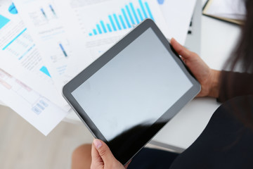 businesswoman study documents hold tablet in her hands closeup a lot of work concept