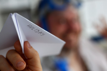 Man wearing suit and tie in goggles and snorkel play with fly paper plane in office closeup. Count days to leave annual day off workaholic freedom fun tourism resort idea ticket sale overseas concept