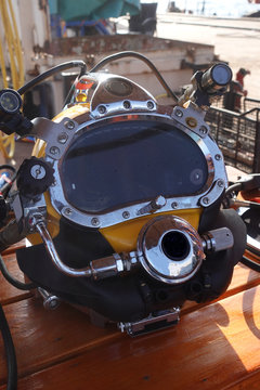 offshore commercial diver with a diving helmet and surface supplied diving equipment