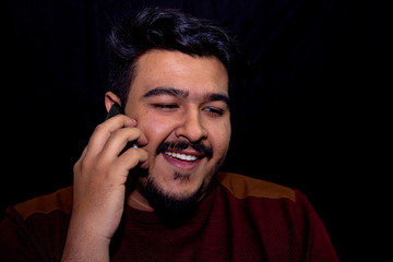 A young guy talking on a mobile phone