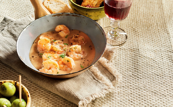 Scampi in cheese cream sauce on rustic table