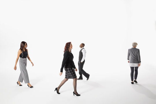 Business People Walking Against White Background