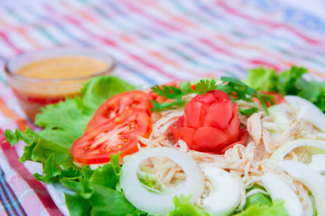 Chiken Salad with tomatoes, lettuce, eggs, onion, Jicama and salad dressing in the small glass bowl. Home made food. Concept for a tasty and healthy meal.