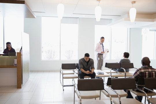 Doctor and patients in clinic waiting room