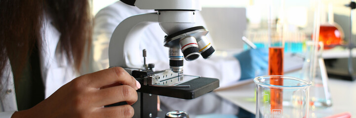 Fototapeta na wymiar Two scientists of a student chemist are conducting research using microscope for bacterial contamination of water to search for vaccine to treat diseases in medicine