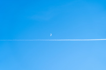 Moon and contrail