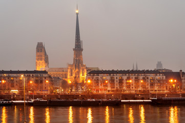 Naklejka premium Rouen cathedral and historic city center along Seine river at night, Normandy, France