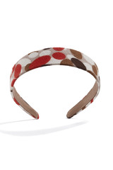 Subject shot of a wide hairband covered with a colorful fabric with abstract print. The stylish headband is isolated on the white background with shadows.