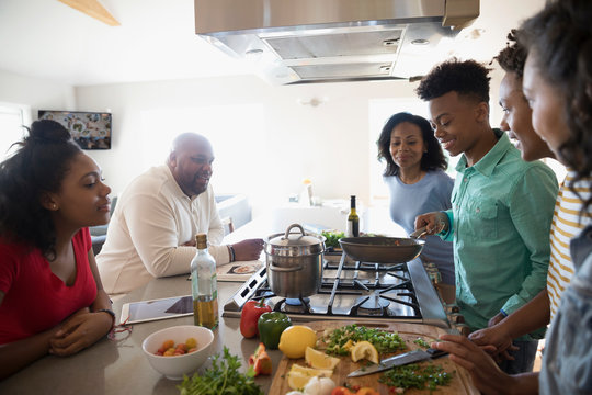 African American Family Cooking In Kitchen