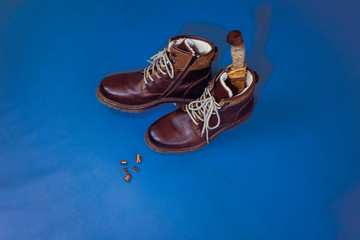 flat lay layout of men's leather accessories. Leather high boots with a knife in the bootleg - a...