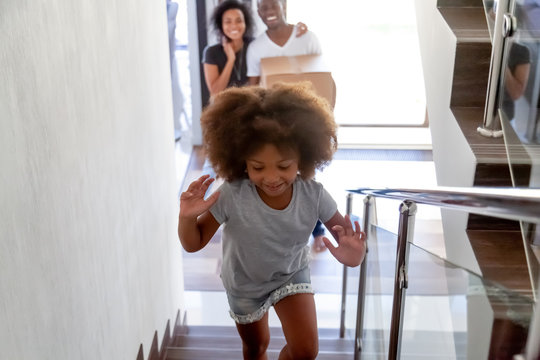 Excited Little Girl Run Upstairs Exploring New Home