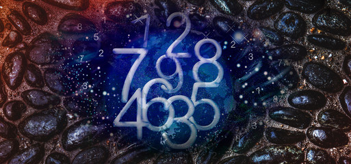 Numbers on the background of black stones, numerology