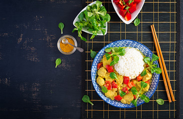 Indian chicken curry with basmati rice in blue bowl.  Traditional Indian dish. Chicken tikka masala. Indian cuisine. Top view, flat lay