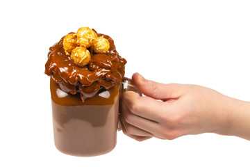 Chocolate milkshake with whipped cream, cookies, waffles, served in glass mason jar. 