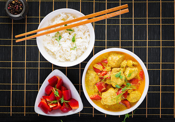 Indian chicken curry with basmati rice in bowl.  Traditional Indian dish. Chicken tikka masala. Indian cuisine. Top view, flat lay