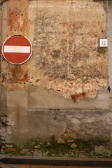 old wall with road sign