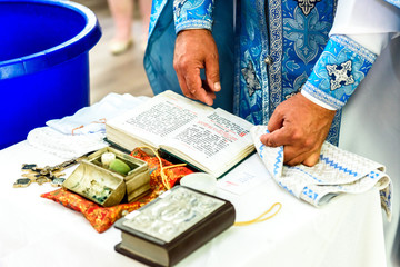 The sacrament of the rite baptism of a child in an Orthodox Christian church. Chan for ablution and...