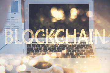 Double exposure of blockchain theme hologram and table with computer background. Concept of bitcoin...