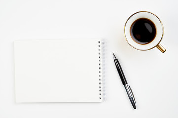 white office Desk top view with Notepad, pen and coffee Cup, minimalistic design, top view,copy space,flat lay