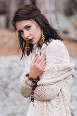 Girl in boho style on a background of autumn forest.