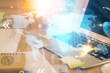 Multi exposure of table with computer and world map hologram. International data network concept.
