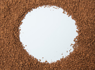 Instant coffee texture background with place for text in the center.
