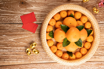 orange and red packet envelope on chinese new year celebration on wooden table