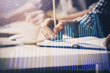 Multi exposure of two men planing investment with stock market forex chart.