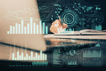 Double exposure of businessman with laptop and stock market forex chart.